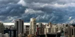 Imagem de tempestade em meio aos prédios no centro de uma cidade.